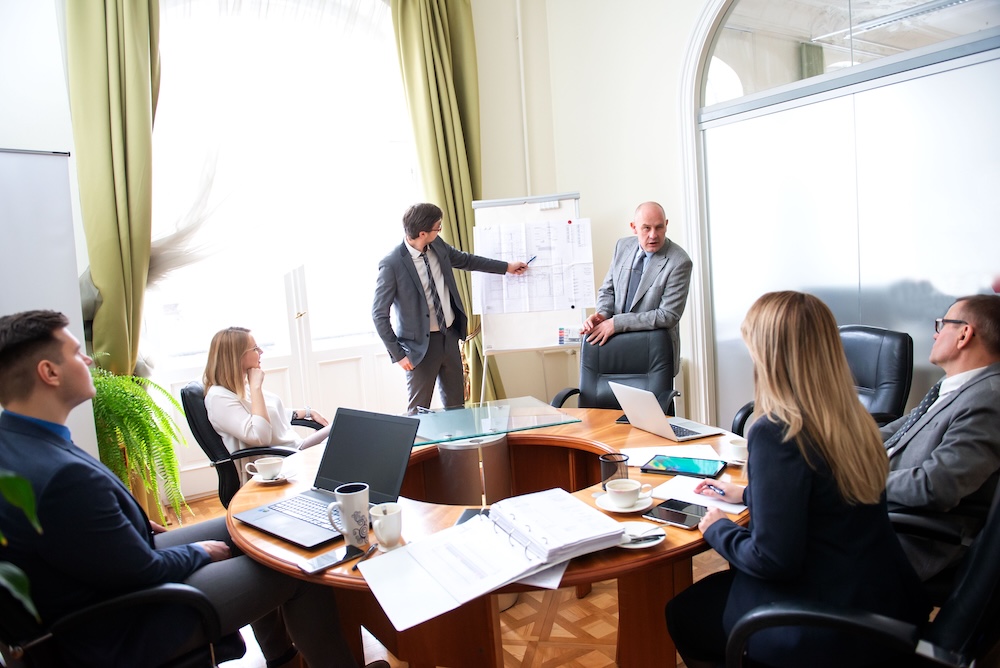 Successful business professionals presenting new project while working together with colleagues